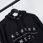 black hoodie with white komera neza embroidered logo