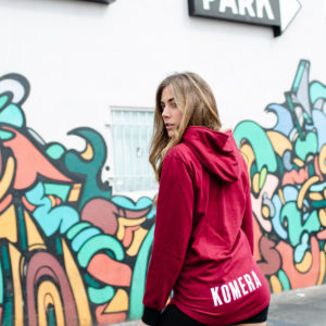 womens burgundy pocketless hoodie with white komera neza print logo
