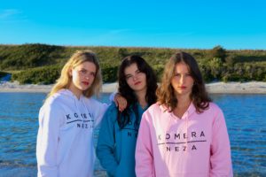 womens white, blue, and pink hoodie with black komera neza print logo