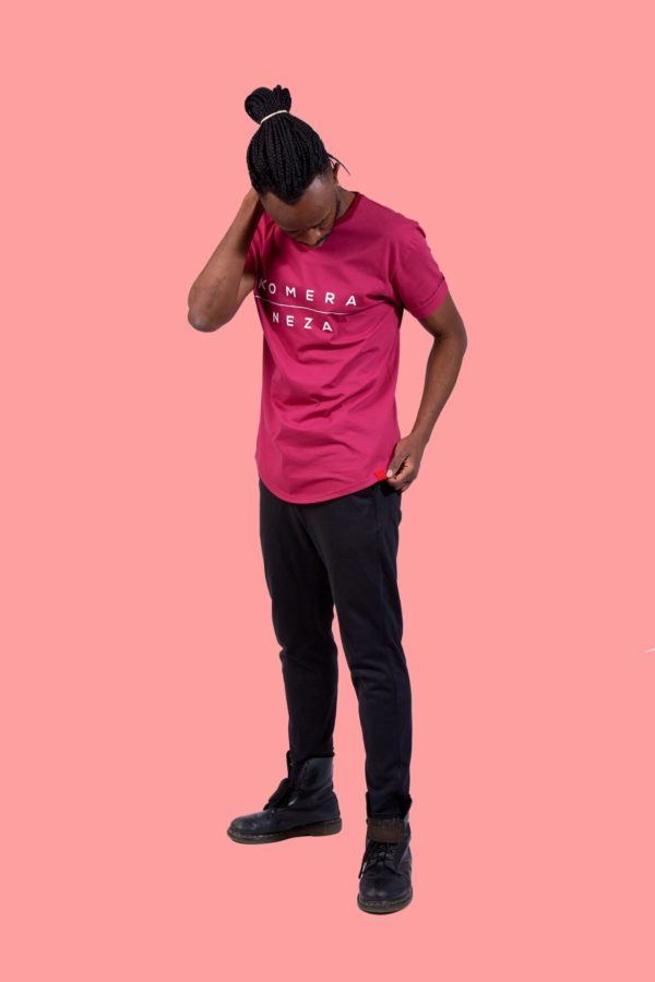 black male wearing burgundy t-shirt with white komera neza print logo