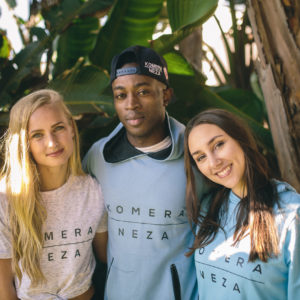 Three people in the wild wearing clothes from KOMERA NEZA